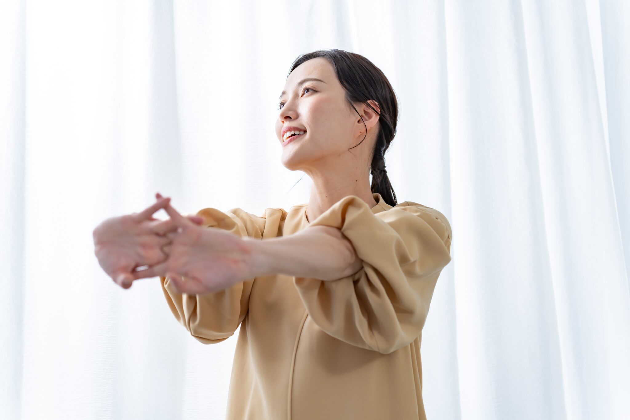 伸びをして微笑む女性